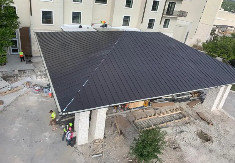 Metal roofing installation team working on a commercial building in Morrilton